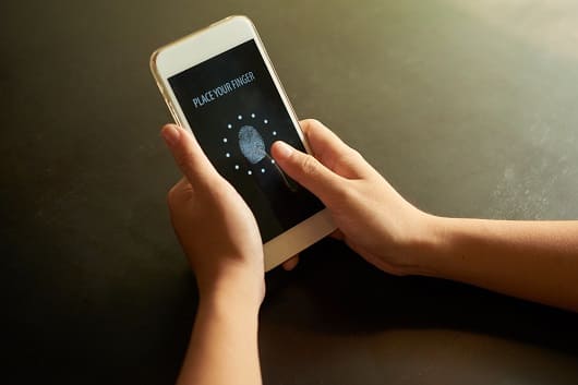 cropped hands placing finger identification spot touchscreen1