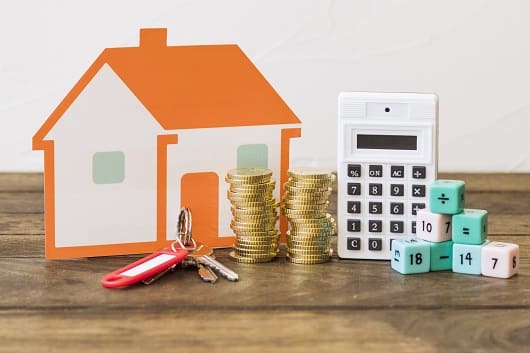 house key stacked coins calculator math blocks wooden table1