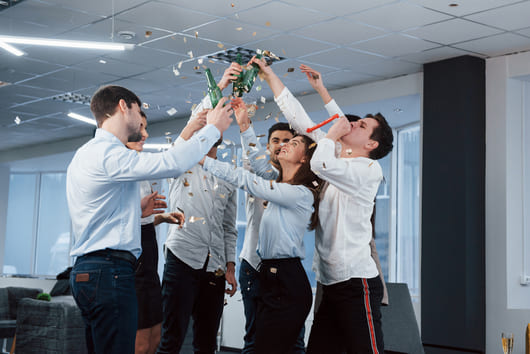 hands up photo young team classical clothes celebrating success while holding drinks modern good lighted office11